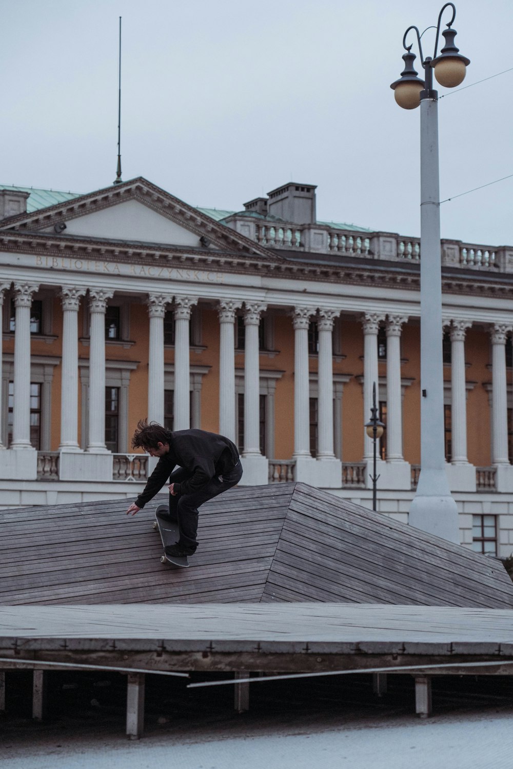 a man riding a skateboard down the side of a wooden ramp