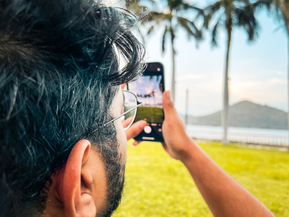 a man taking a picture of himself with a cell phone