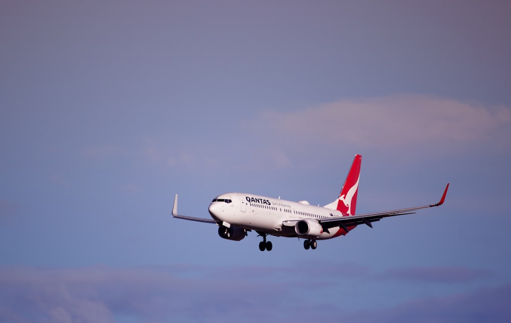 a large jetliner flying through a blue sky