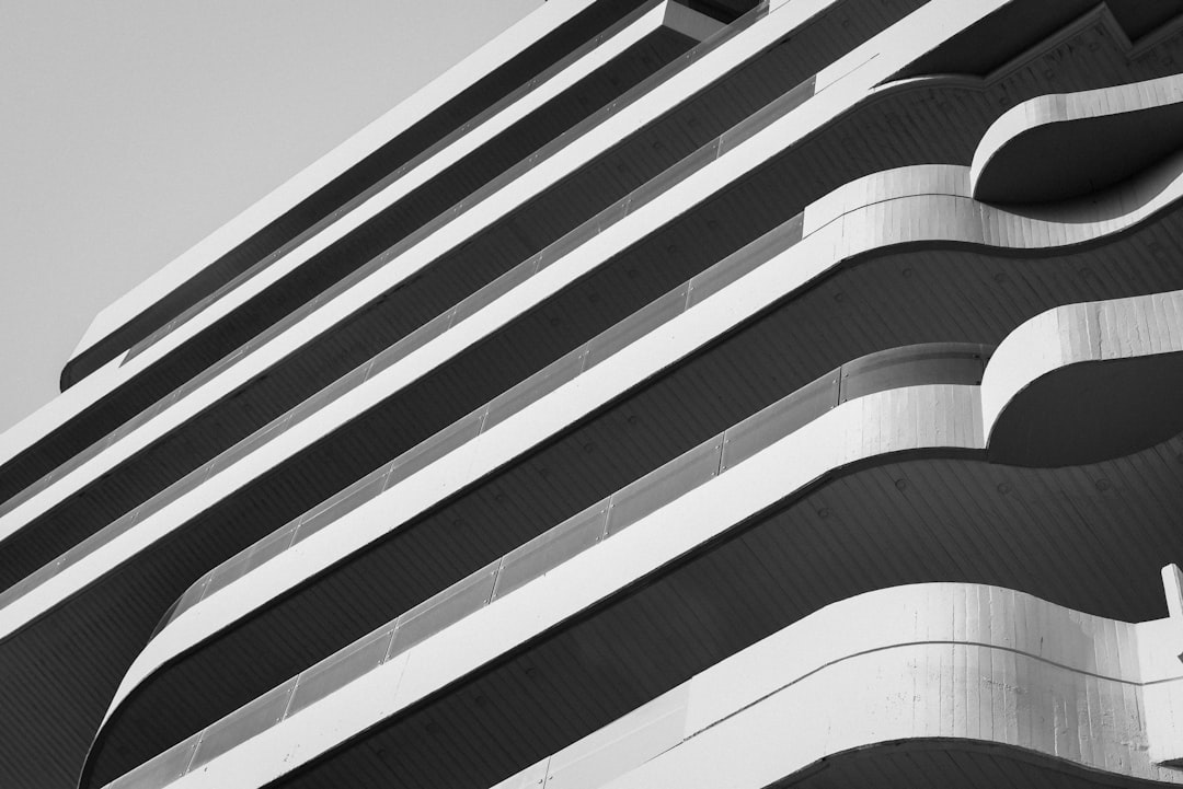 a black and white photo of a building, Developer of one of the residential buildings