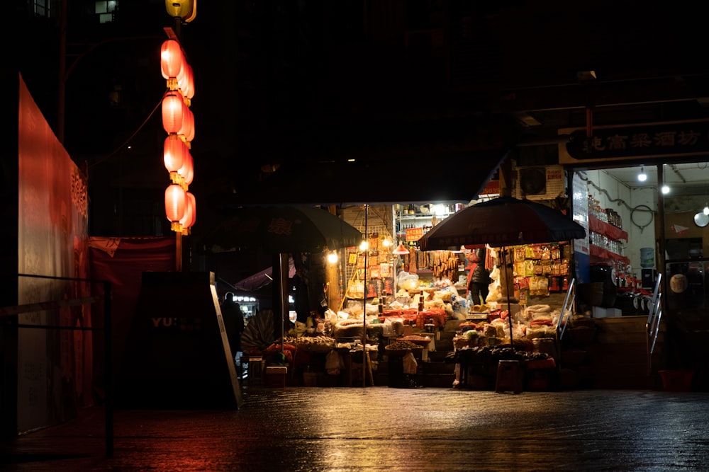 a night market with a lit up umbrella