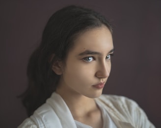 a close up of a person wearing a white shirt
