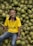 A farmer smiling while holding fresh produce from the cooperative.
