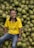 A farmer smiling while holding fresh produce from the cooperative.