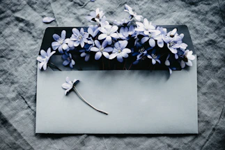 a gray envelope with a bunch of blue flowers on it