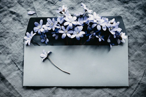 a gray envelope with a bunch of blue flowers on it