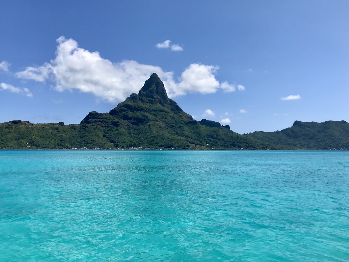 Matira Beach Bora Bora — the white sand public beach at Matira Point with turquoise lagoon water and the volcanic peaks visible in the distance