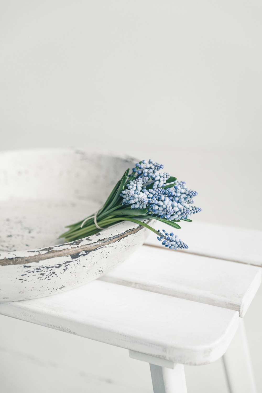 a bouquet of flowers sitting in a white bowl