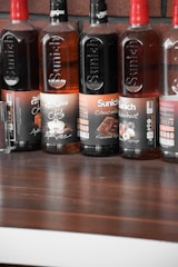 A vibrant display of various ice cream syrups in colorful bottles.