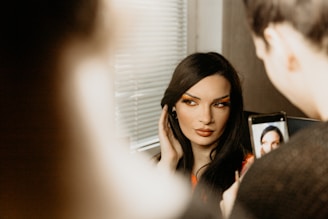 a woman is looking in a mirror with her face painted