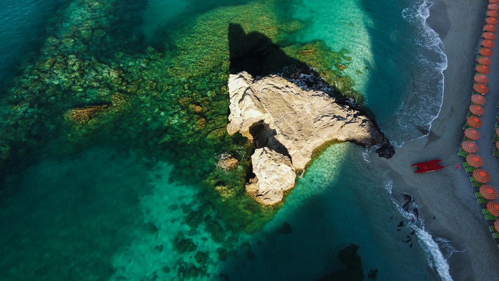 an aerial view of a rock formation in the ocean