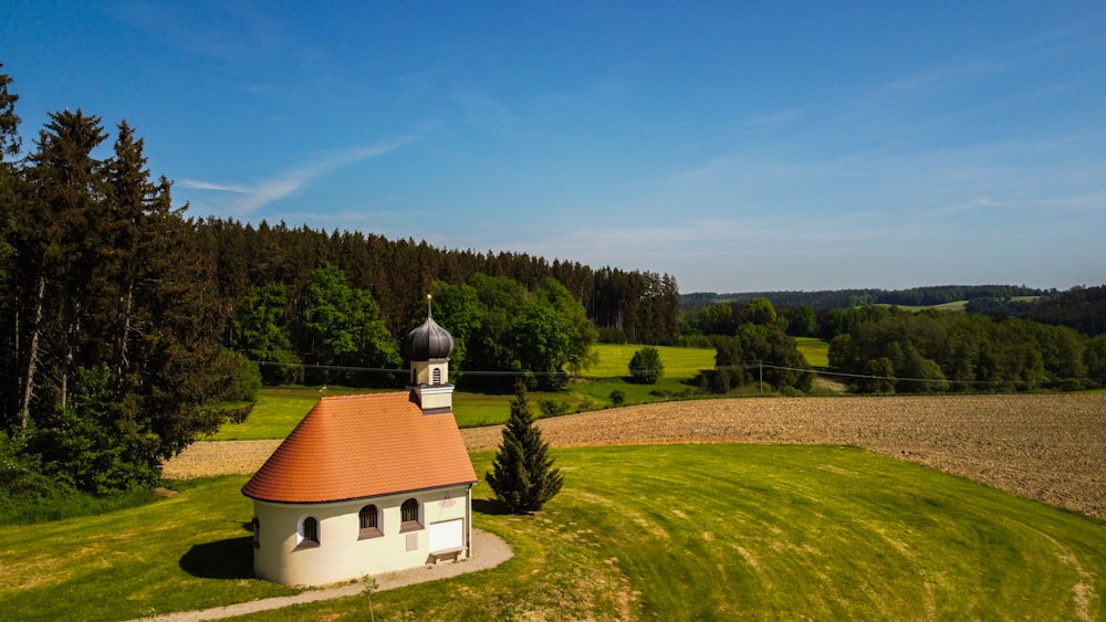 a small church in the middle of a field