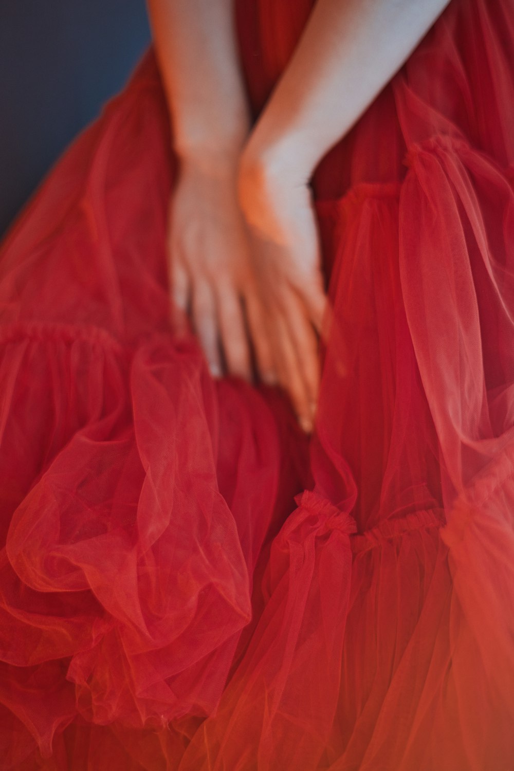 a woman in a red dress is sitting down