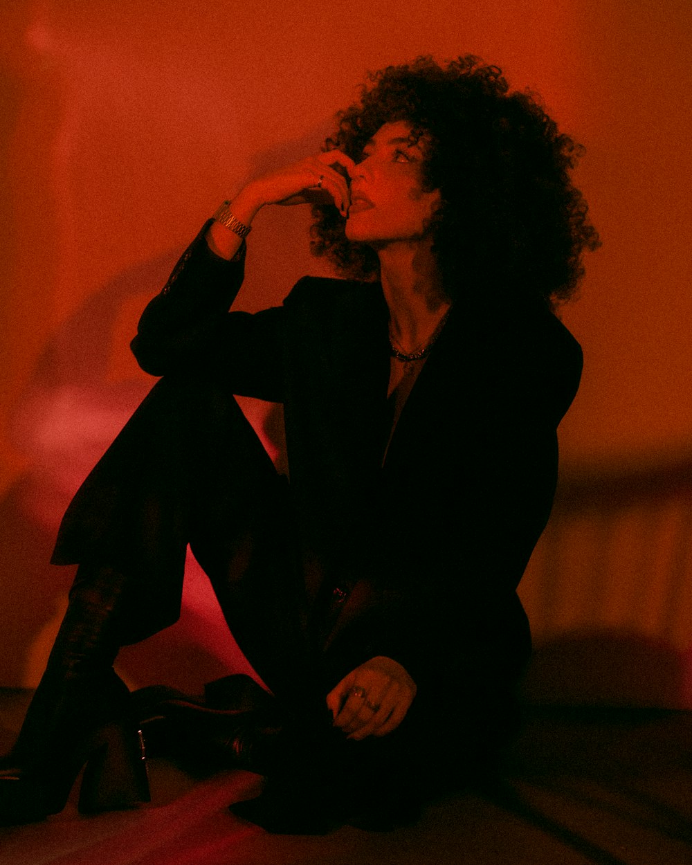 a woman sitting on the floor in a dark room