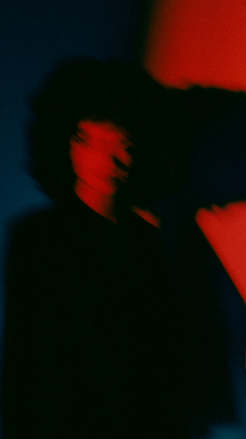 a blurry image of a person in a dark room