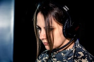 a woman wearing a headset and looking down
