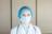a female doctor wearing a blue surgical mask
