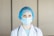 a female doctor wearing a blue surgical mask