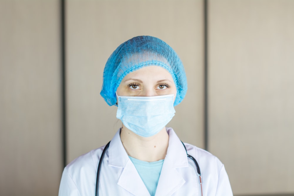 a female doctor wearing a blue surgical mask