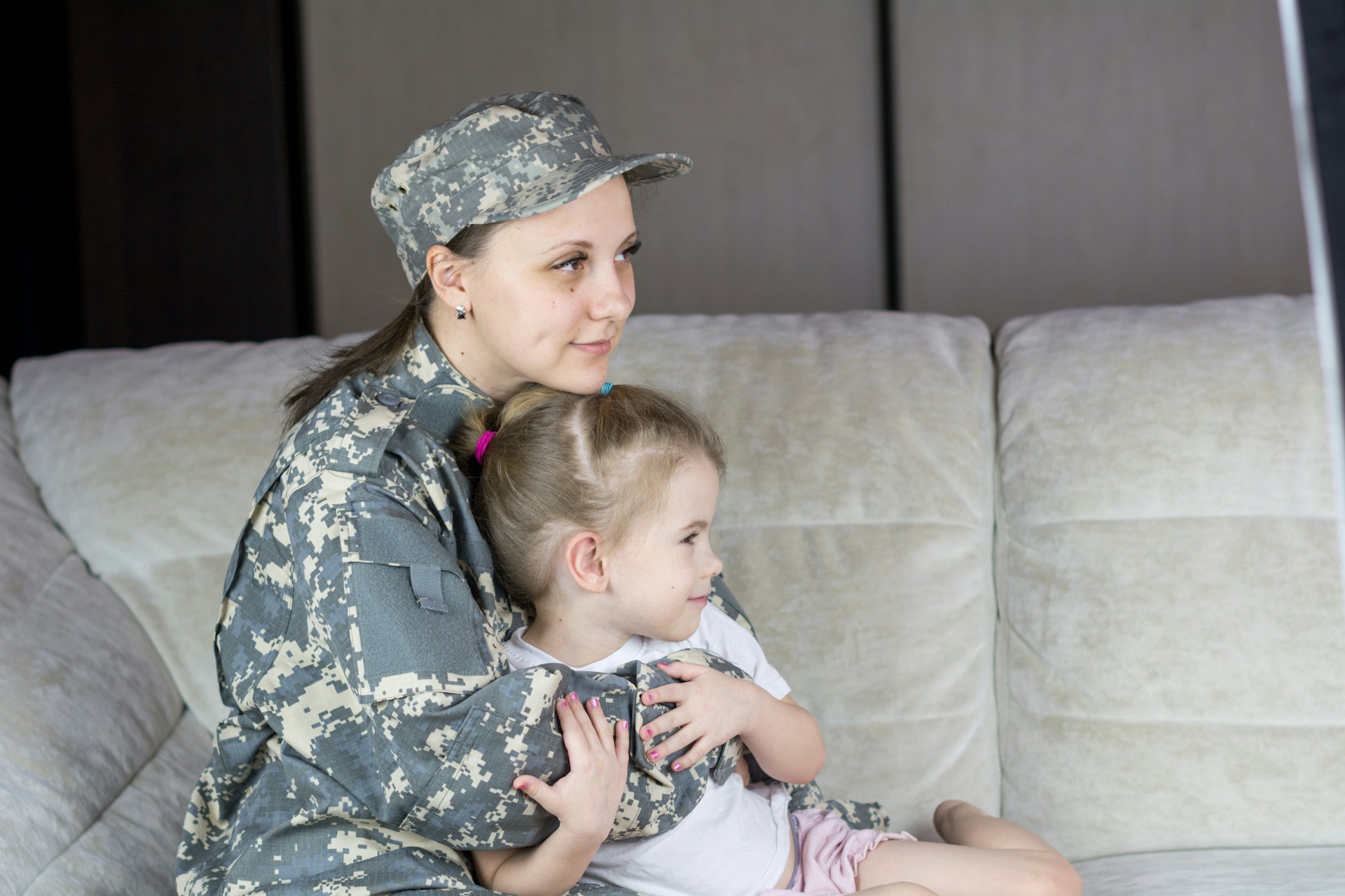 Military mother embracing her child