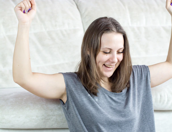Joyful winner celebrating after hitting a big online slot jackpot on laptop
