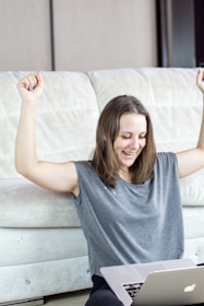 A person happily using a laptop, showcasing a successful online referral program.