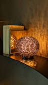 Artisan lamp casting a warm glow over a cozy reading nook with wooden details.
