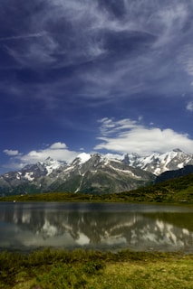 Snow-capped peaks reflecting in a pristine lake in the Swiss Alps