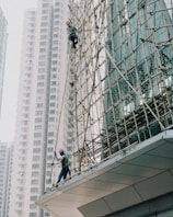 a man on a scaffold working on a building