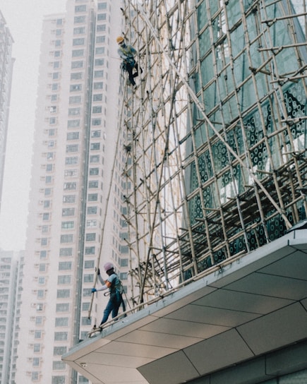 a man on a scaffold working on a building