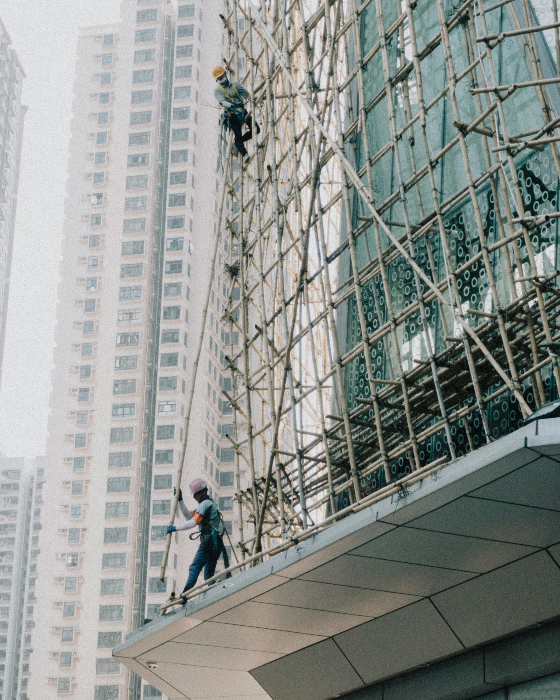 a man on a scaffold working on a building