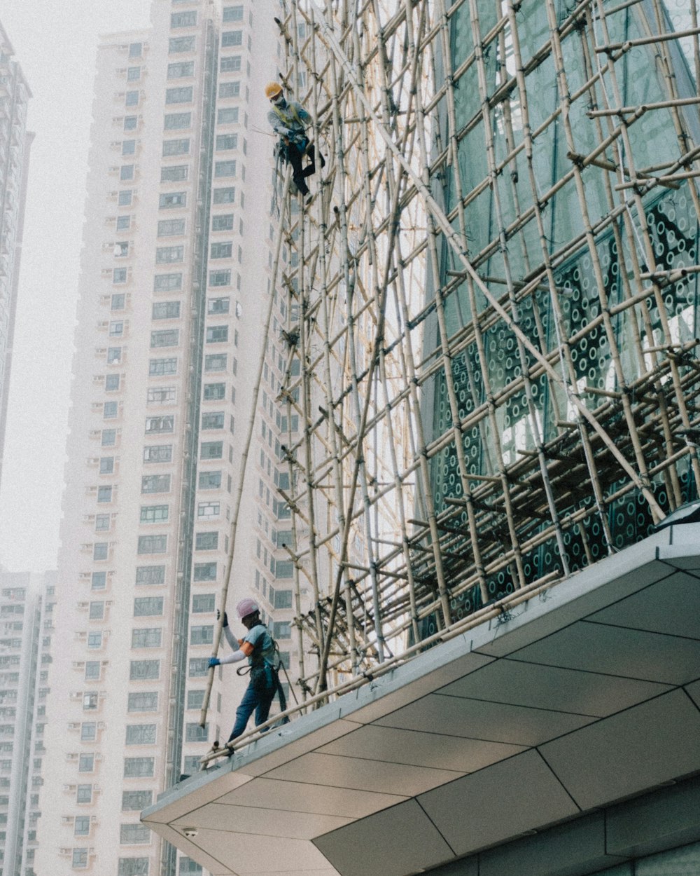 a man on a scaffold working on a building