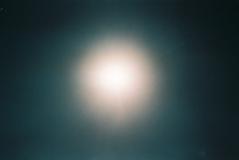 Cinematic dark mode hero banner with deep emerald and black gradient background featuring volumetric light rays and subtle particle glow.