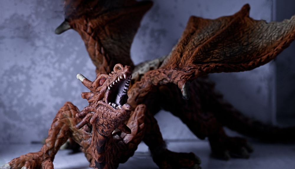 a close up of a toy dragon on a table