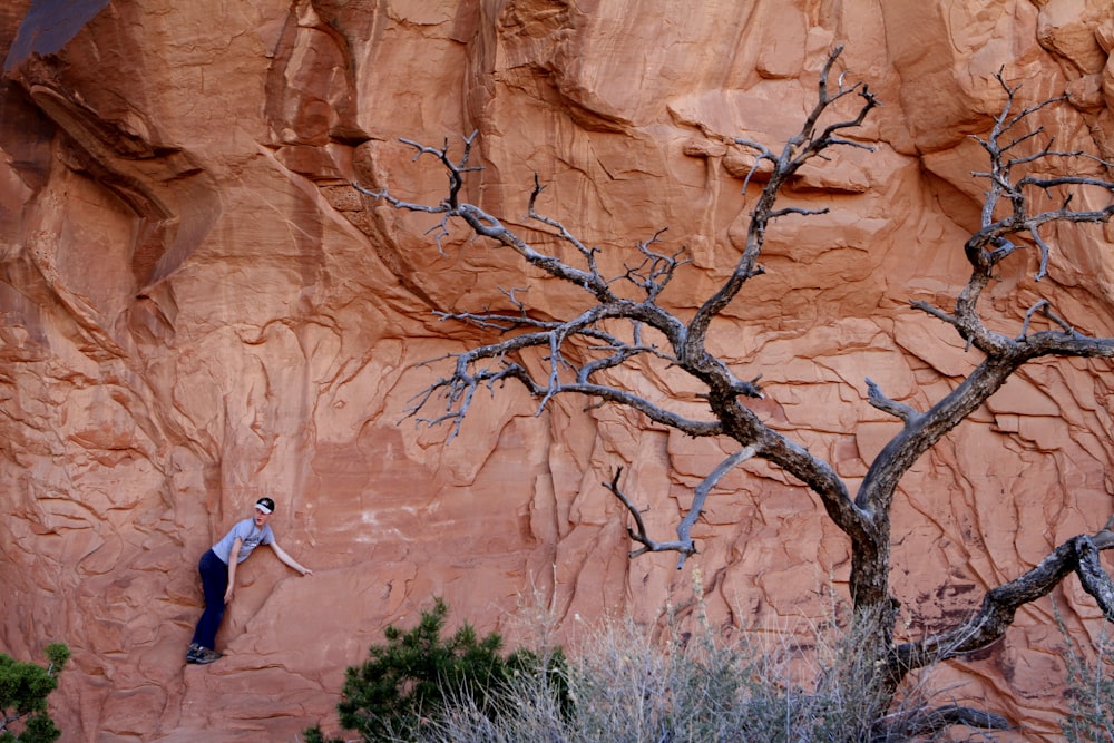 a man climbing up the side of a cliff