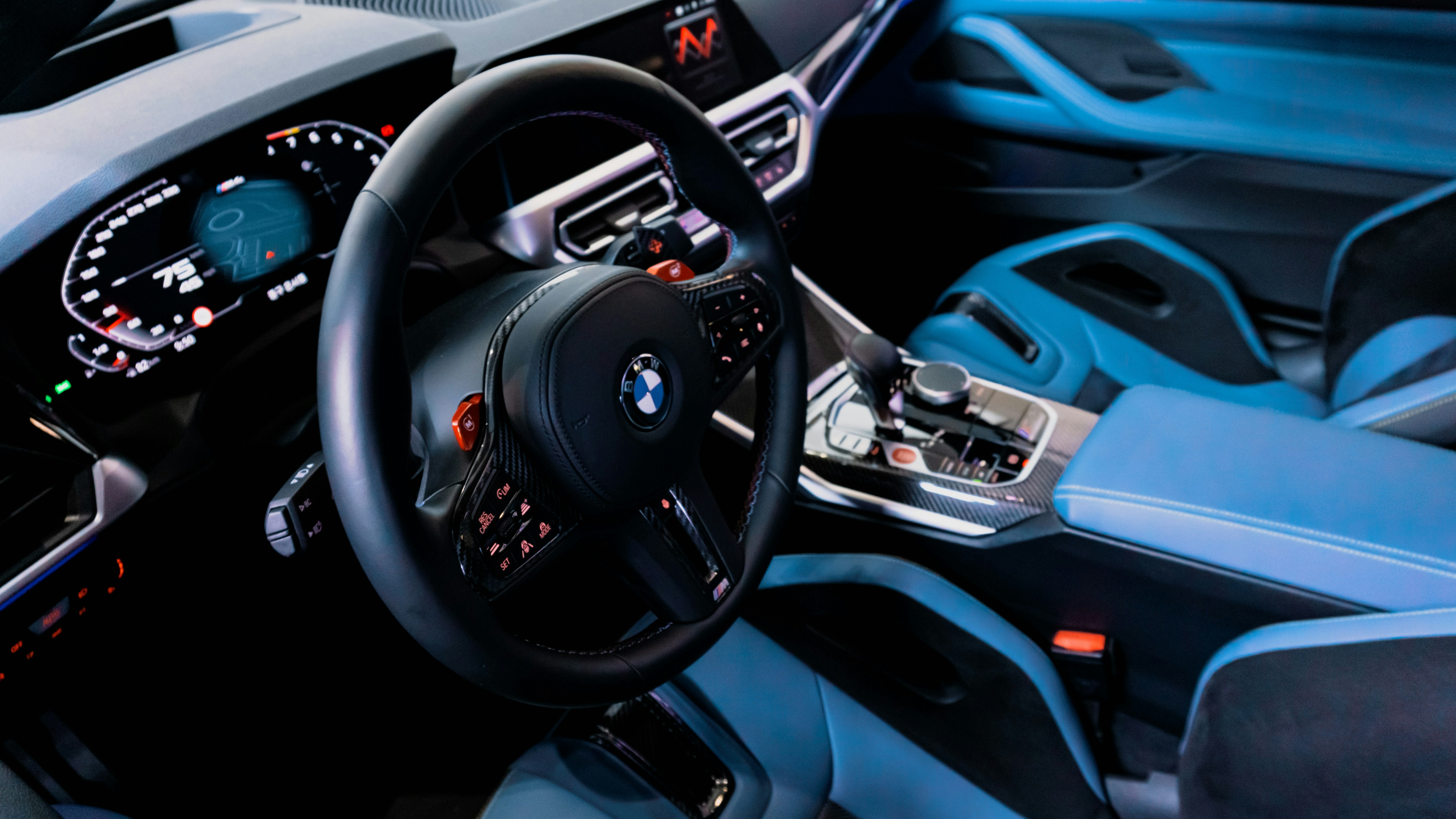 the interior of a car with a steering wheel and dashboard