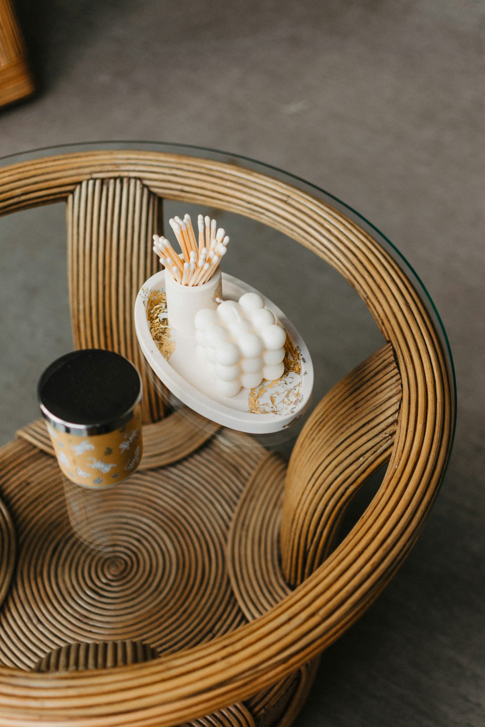 a table with a glass top and a vase on top of it