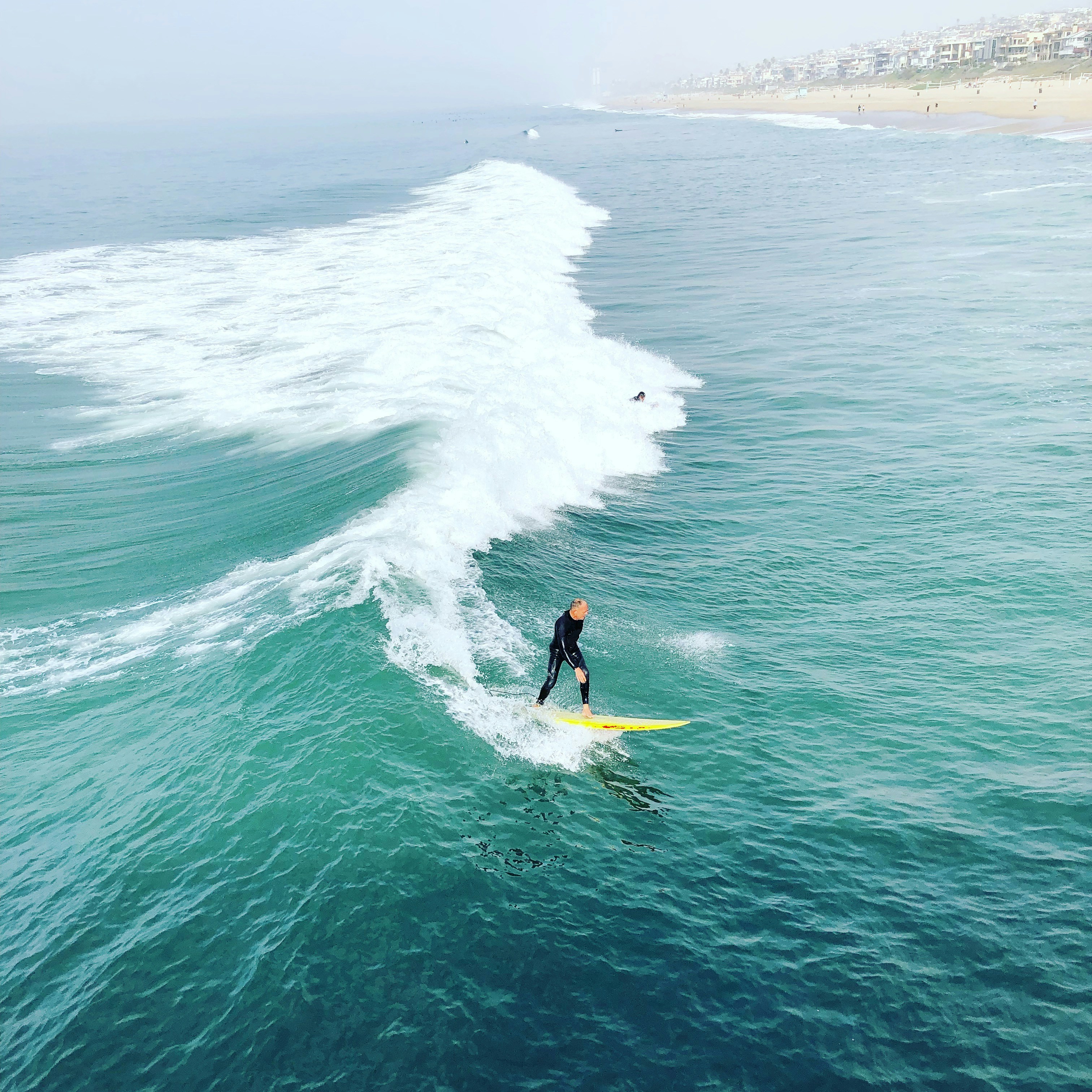 A man riding a surfboard on top of a wave in the ocean photo – Free Sea ...
