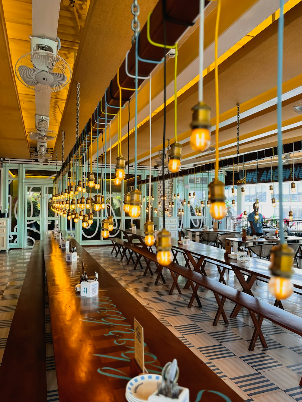 a restaurant filled with lots of tables and chairs