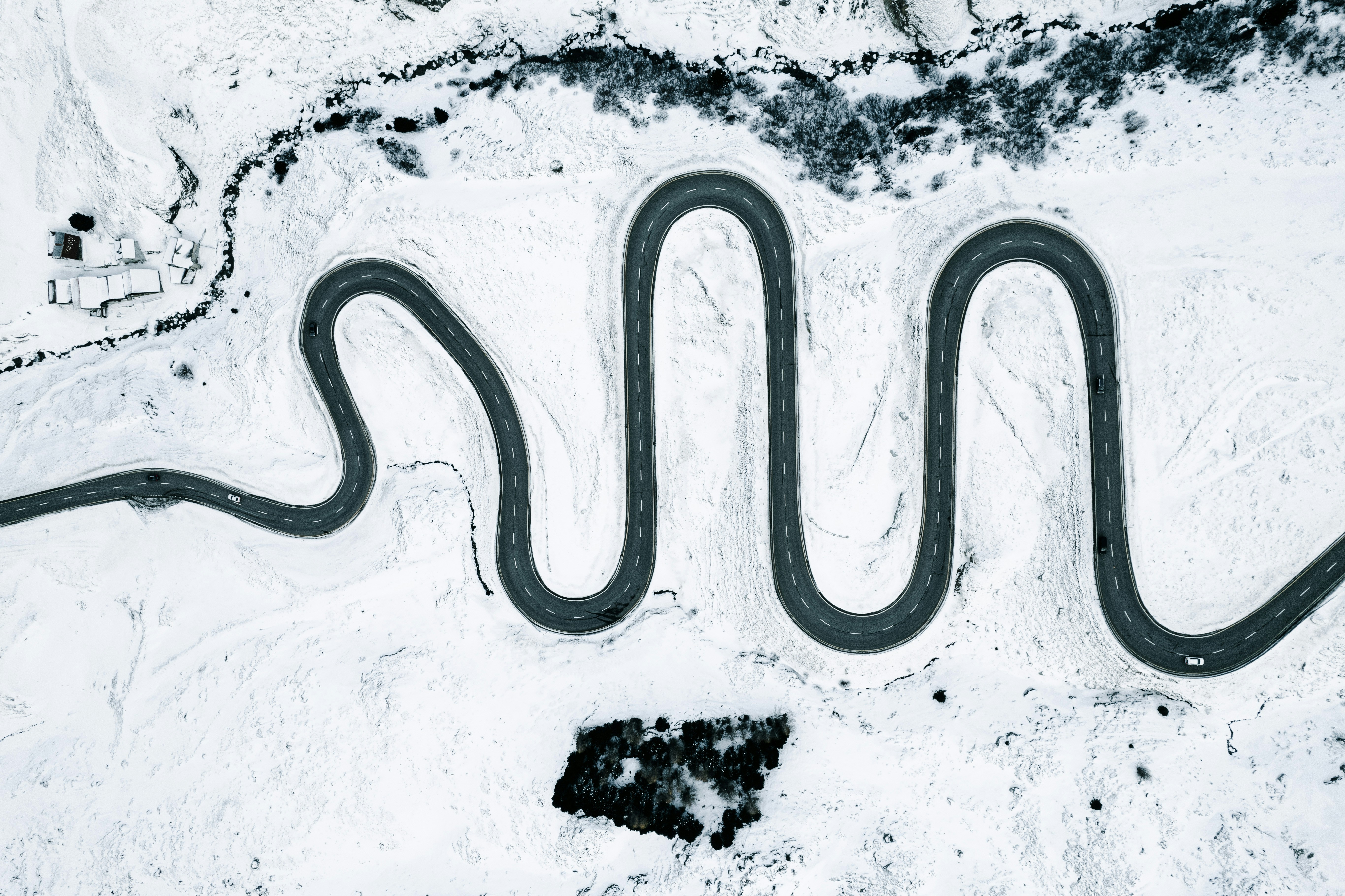 a group of three road curves in the snow