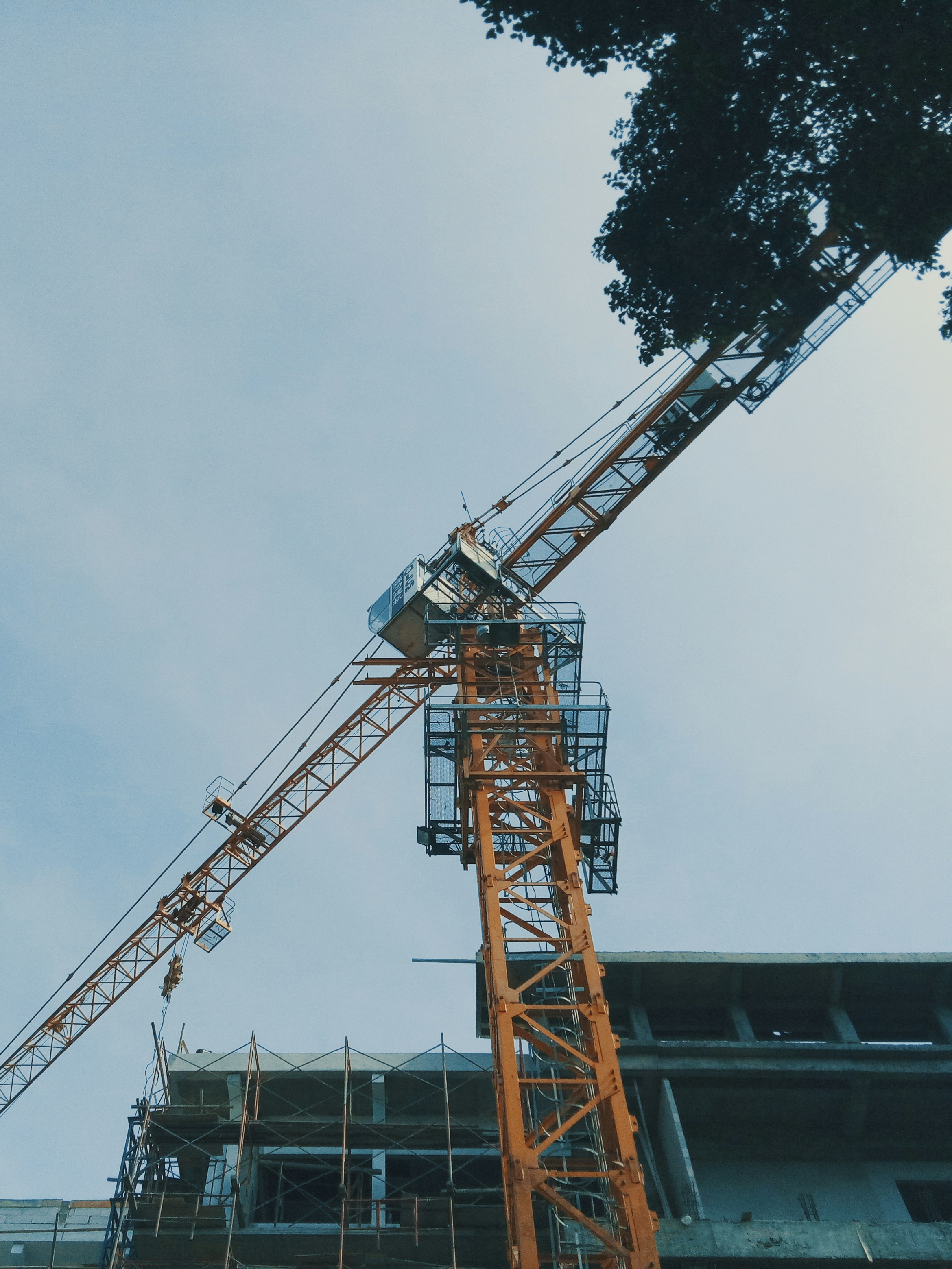a crane is standing in front of a building
