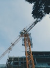 a crane is standing in front of a building