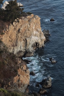 A rugged coastline with dramatic sea cliffs and crashing waves.