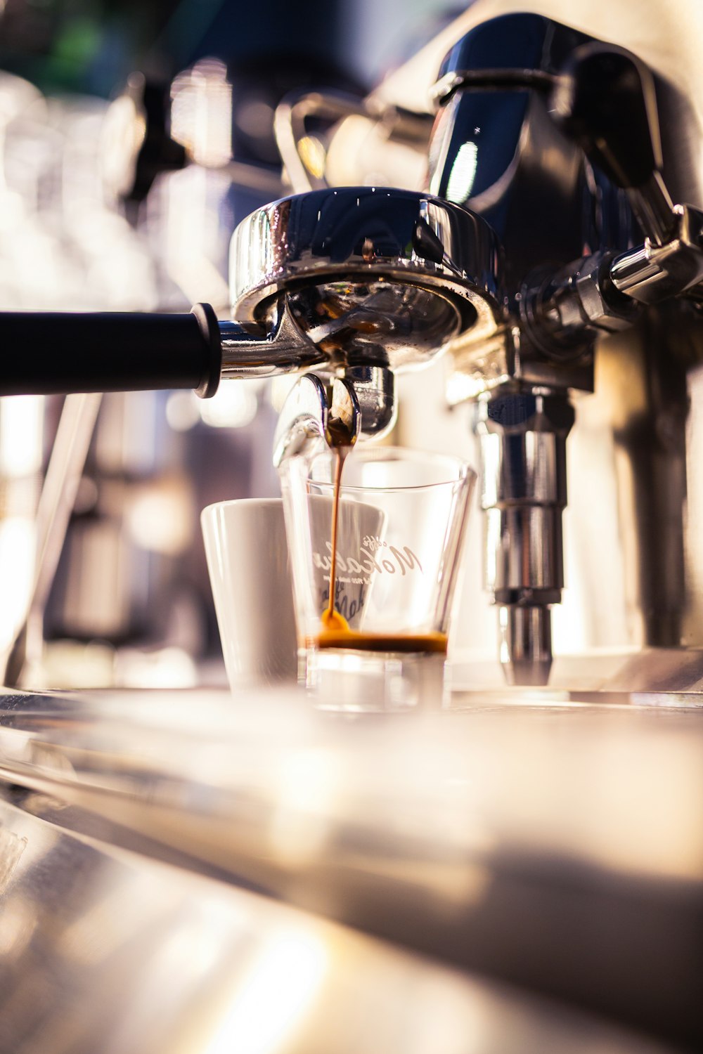 a close up of a coffee machine making a cup of coffee