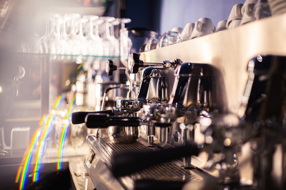 a close up of a coffee machine with a rainbow in the background