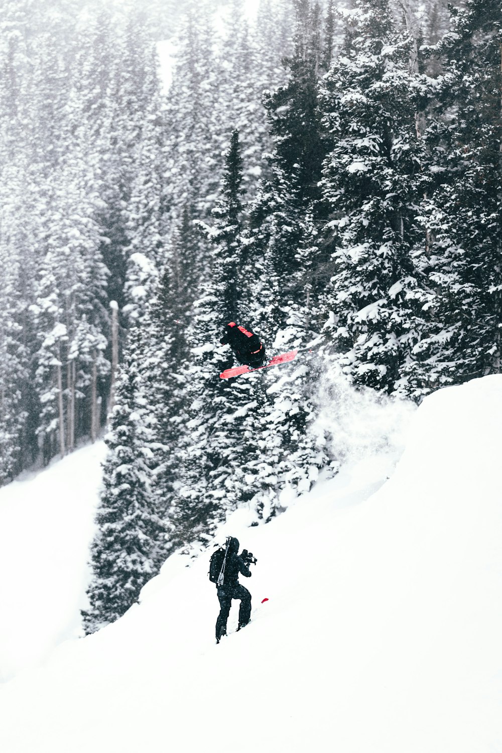 a man flying through the air while riding a snowboard