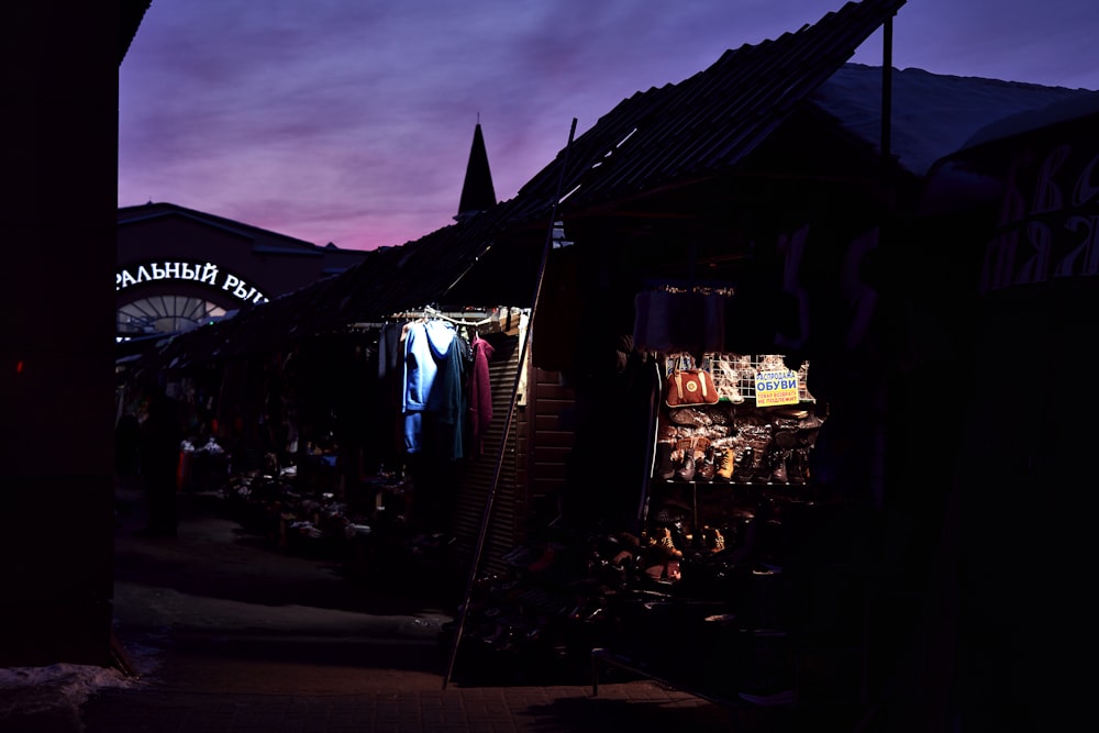 a night market with a purple sky in the background