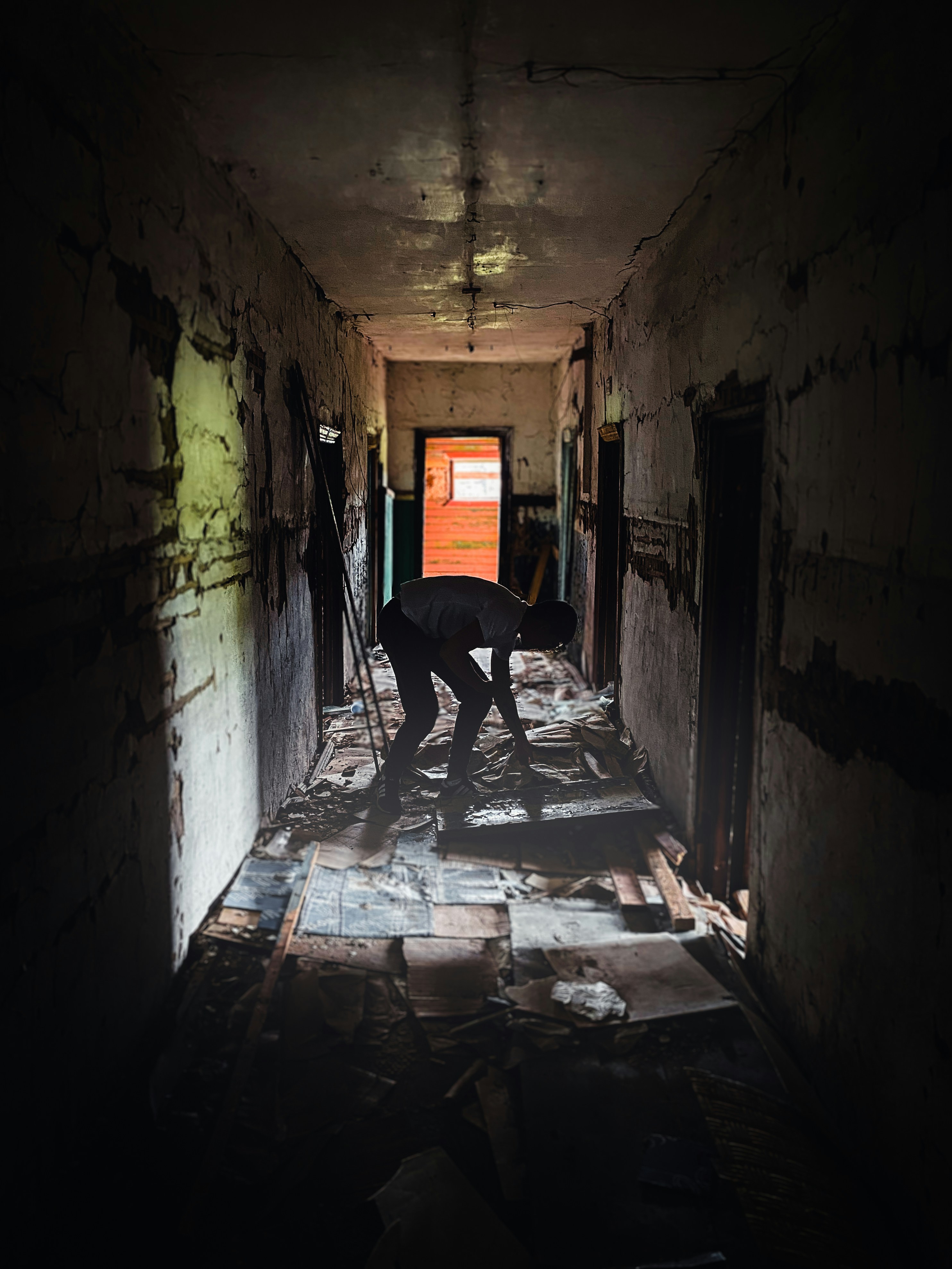 a man is standing in a dark hallway