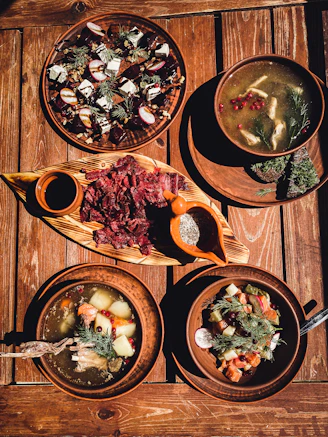 a wooden table topped with plates of food