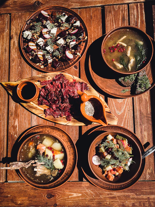 a wooden table topped with plates of food